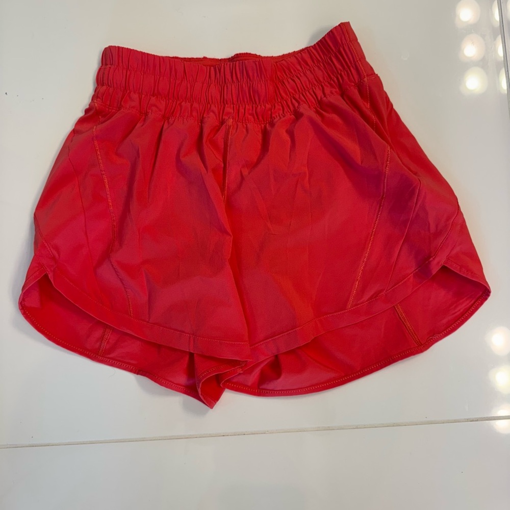Lululemon Track That women’s athletic shorts in a coral color. Size 4.